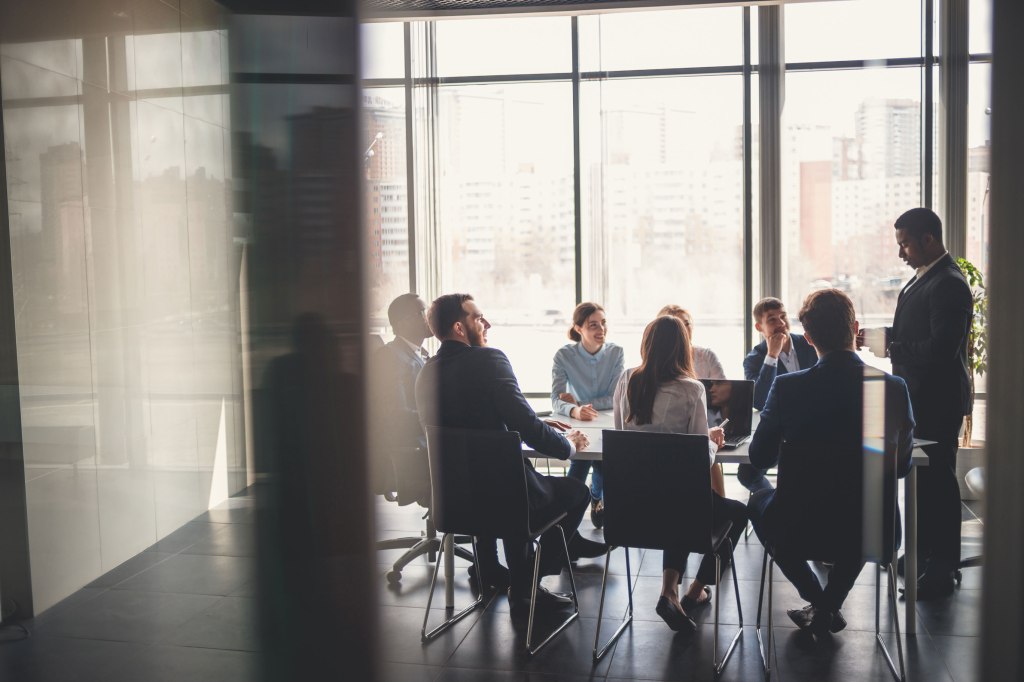 Inclusive development and growth: Business people working in conference room