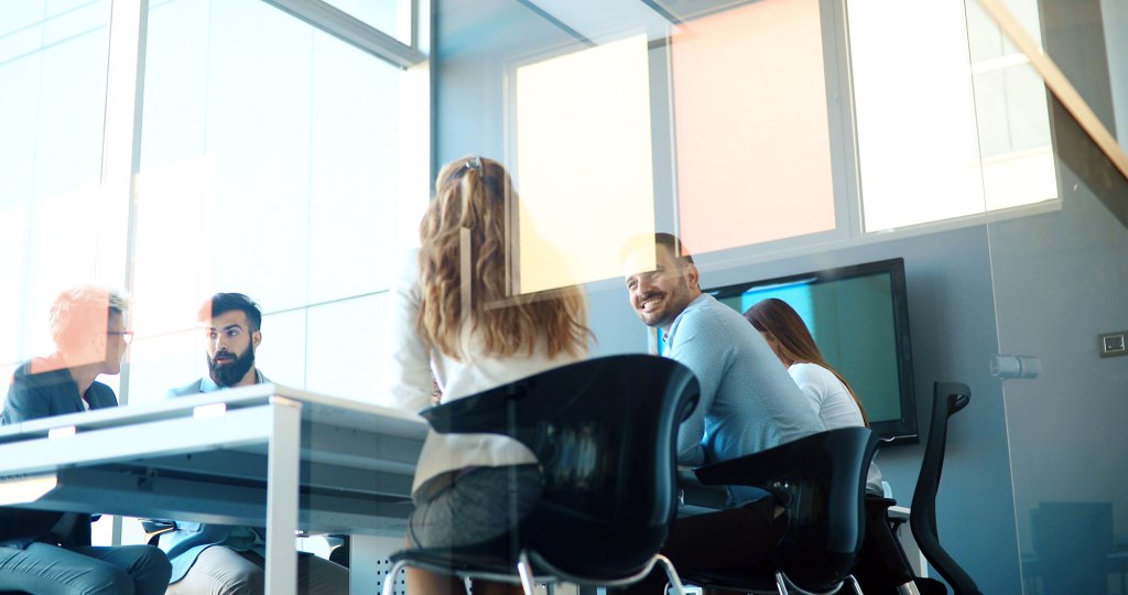 Experienced professionals sitting around a meeting room table