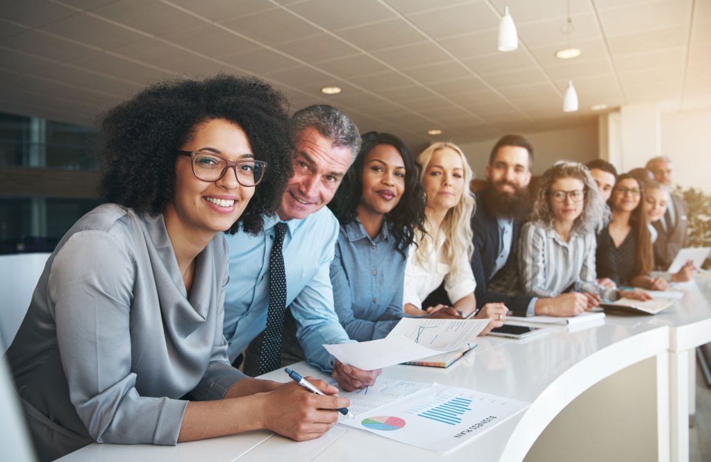 Smiling group of diverse colleagues working together in an office