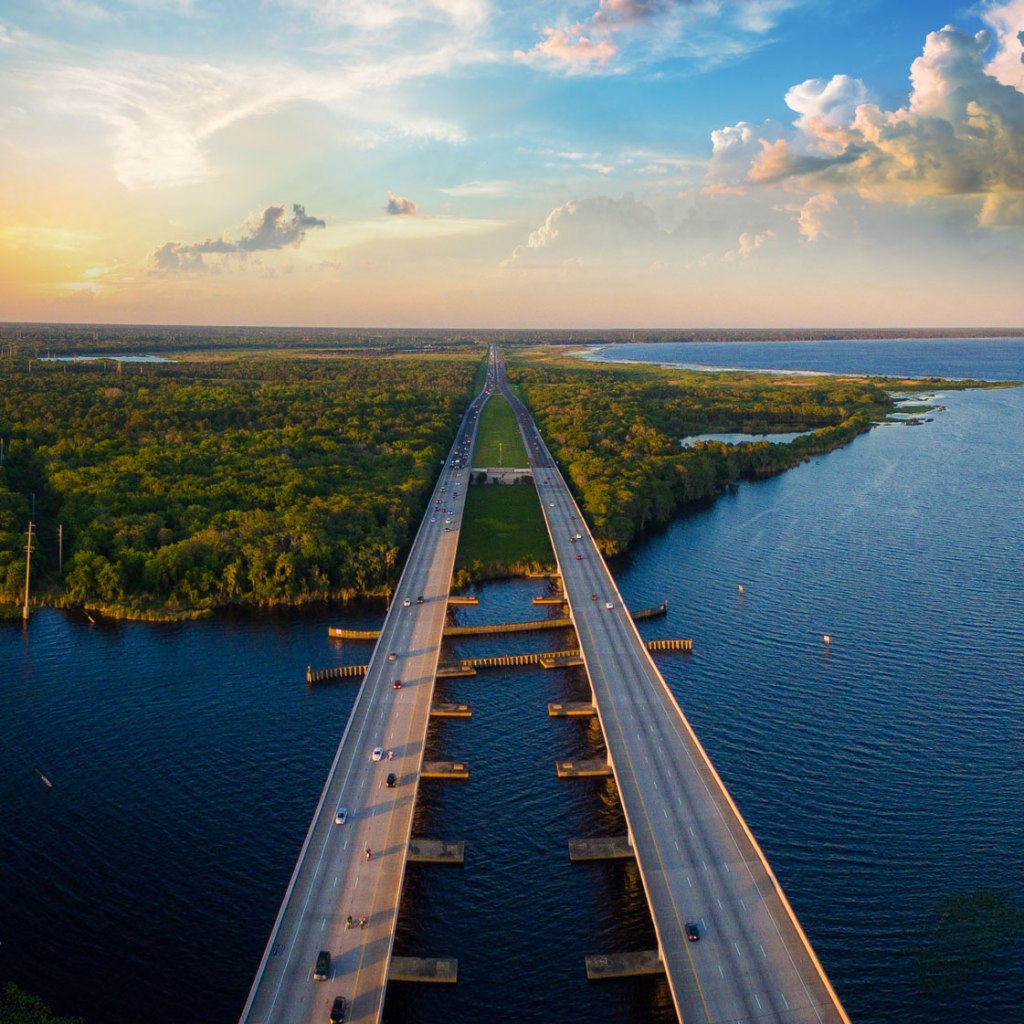 Bridge over water connecting a verdant inlet