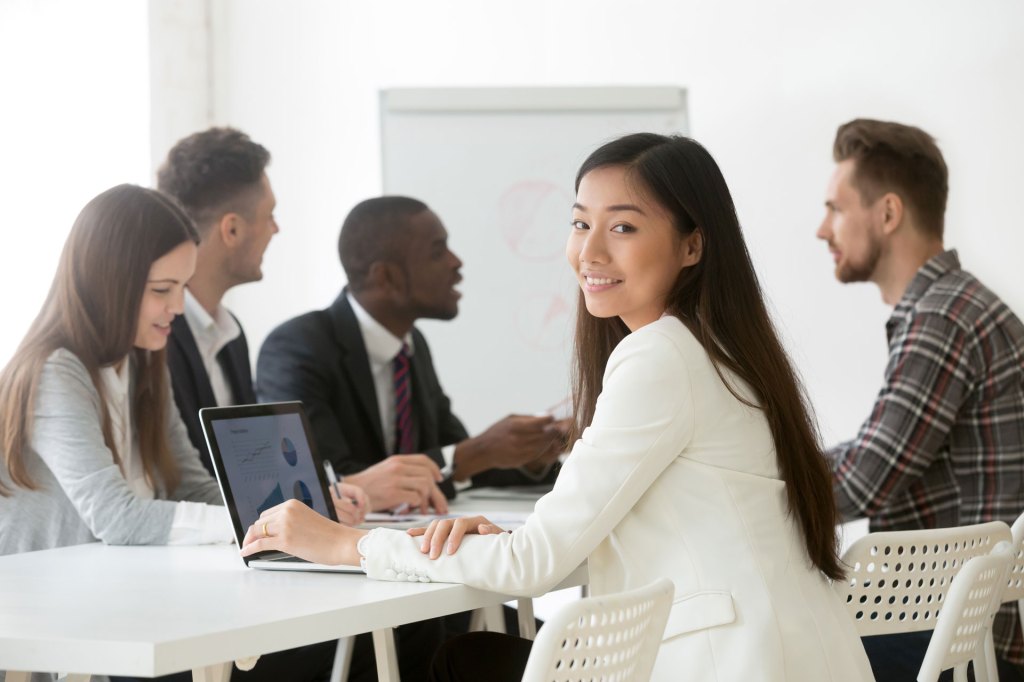 Diverse interns at a working table